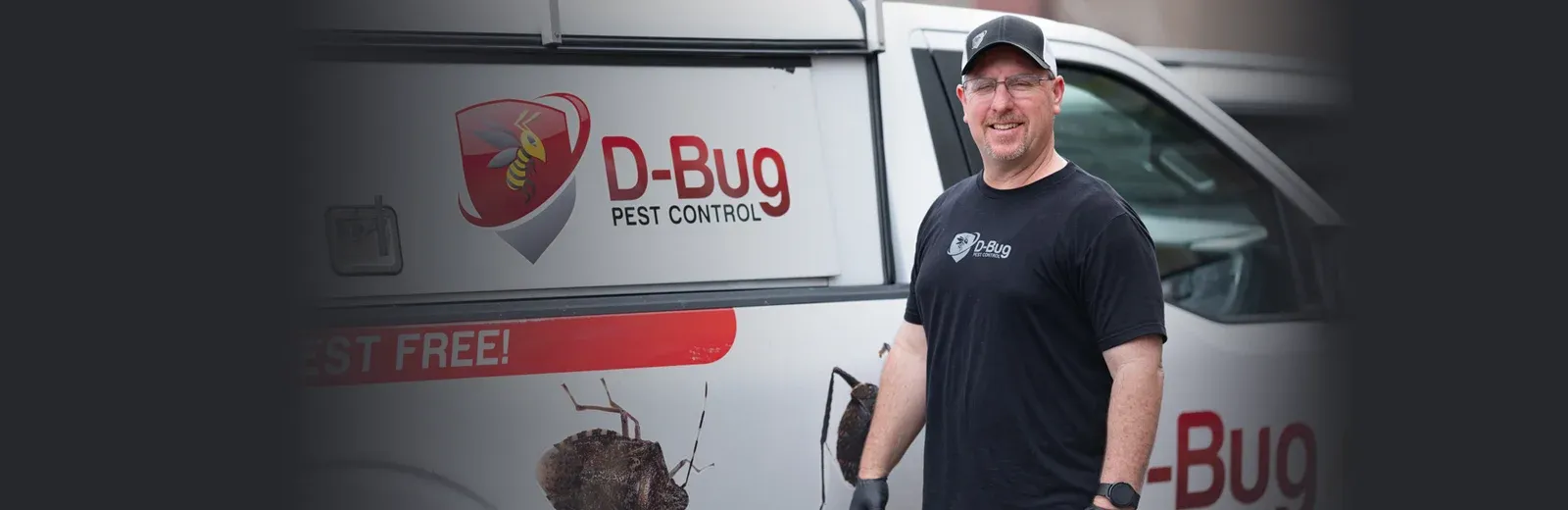 D-Bug Pest Technician standing next to truck