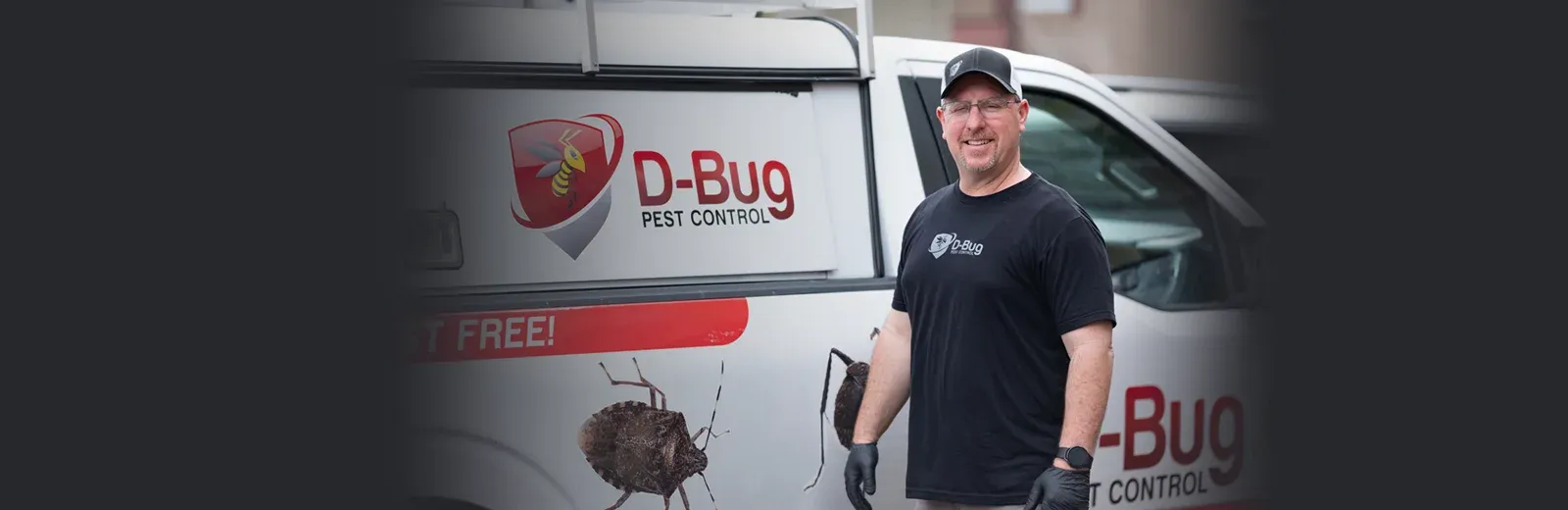 D-Bug Pest Technician standing next to truck